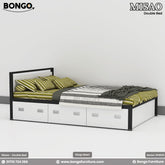 A modern platform bed with a black frame and white panels. The rectangular headboard has a white inset panel, and the base contains three large white storage drawers with silver handles. The bed is styled with green striped bedding.